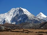 Kongma La 22 Island Peak Close Up From Near Dingboche, Cho Polu Is on The Right There is a good view of Island Peak (Imja Tse, 6189m), with Cho Polu on the right, on the descent from the Kongma La towards Bibre. The peak was named Island Peak in 1952 by Eric Shipton since it looked like an island in a sea of ice. Island Peak was first climbed in 1953 by a British team as a training exercise in preparation for Mount Everest. Tenzing Norgay was one of the members of this first ascent team.